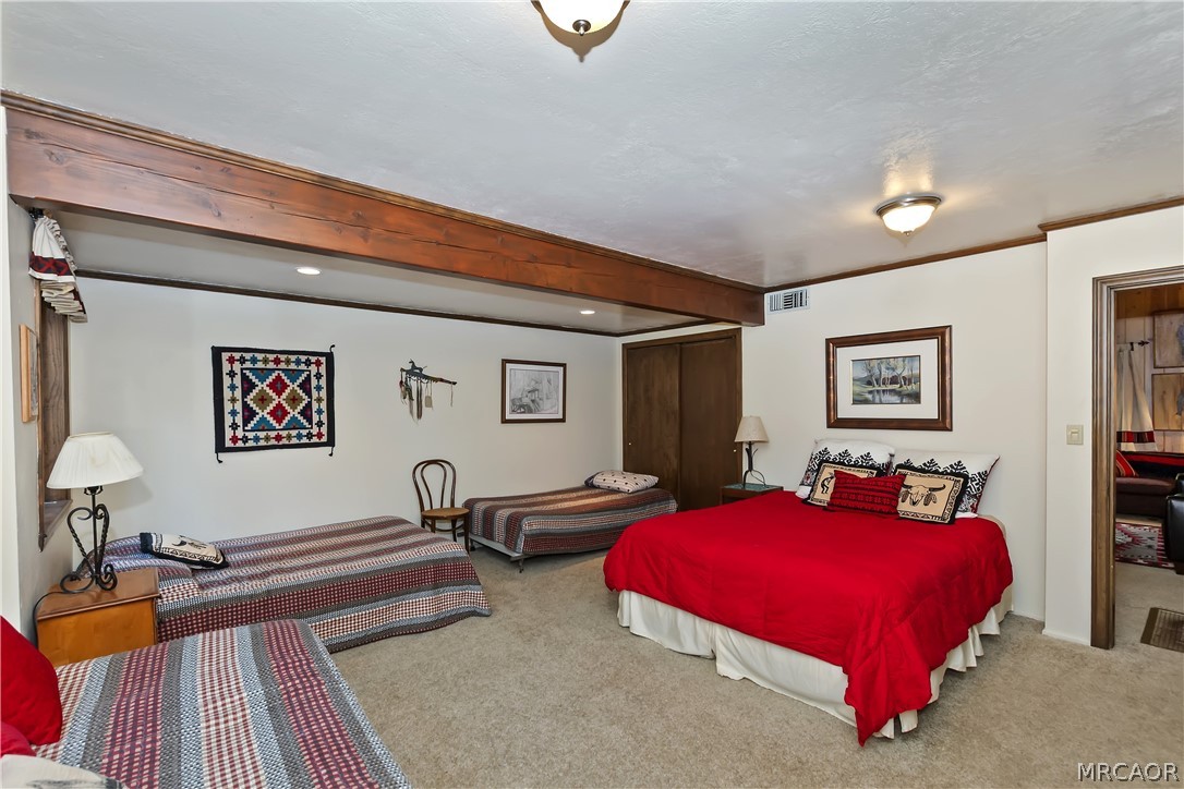 691 Cottage Grove Road Lake Arrowhead, CA 92352 - Photo 18 of 28 a bedroom with furniture and a wooden floor