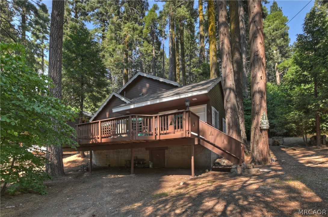 691 Cottage Grove Road Lake Arrowhead, CA 92352 - Photo 2 of 28 a view of a house with a balcony and trees