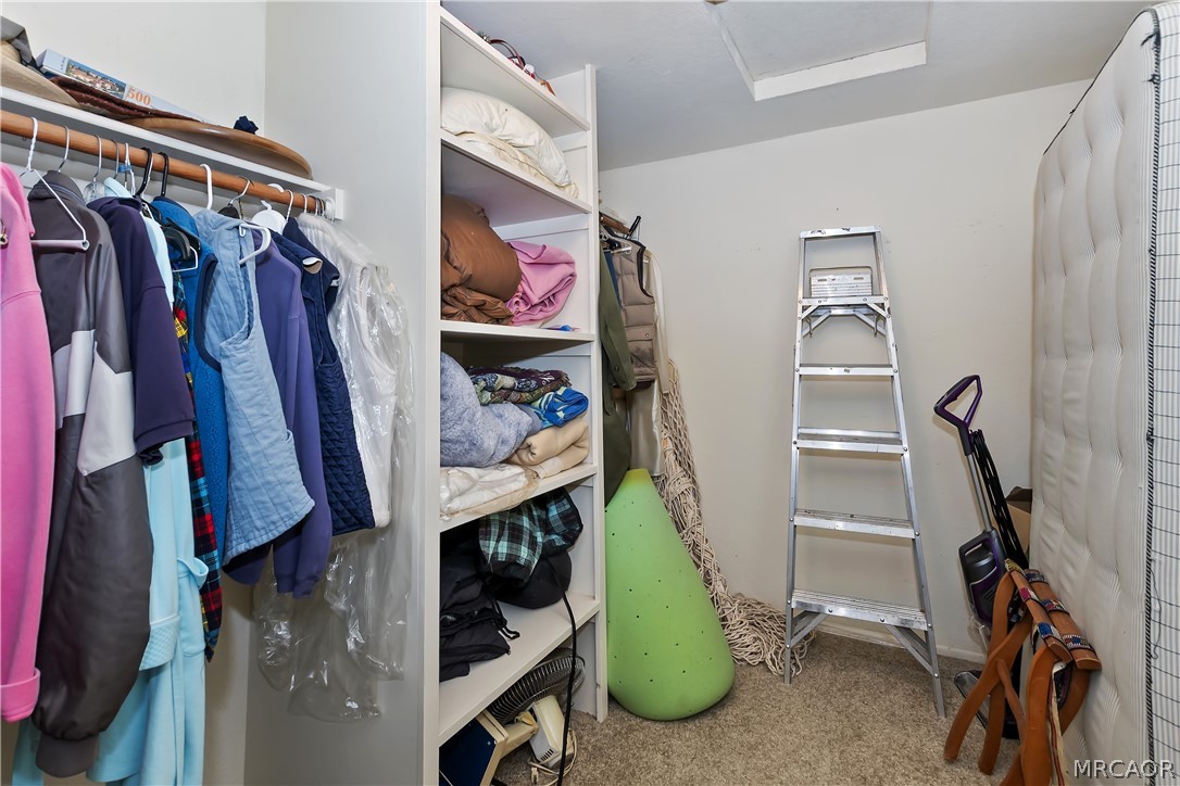 691 Cottage Grove Road Lake Arrowhead, CA 92352 - Photo 27 of 28 a view of walk in closet with clothes and shoes