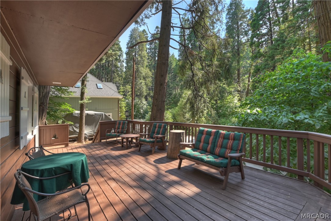691 Cottage Grove Road Lake Arrowhead, CA 92352 - Photo 8 of 28 a view of balcony with couch and chairs