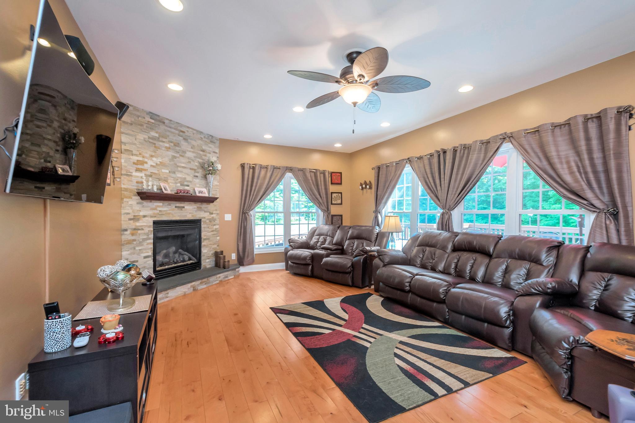 45 Crowncrest Road Fredericksburg, VA 22406 - Photo 15 of 17 a living room with furniture a fireplace and a flat screen tv