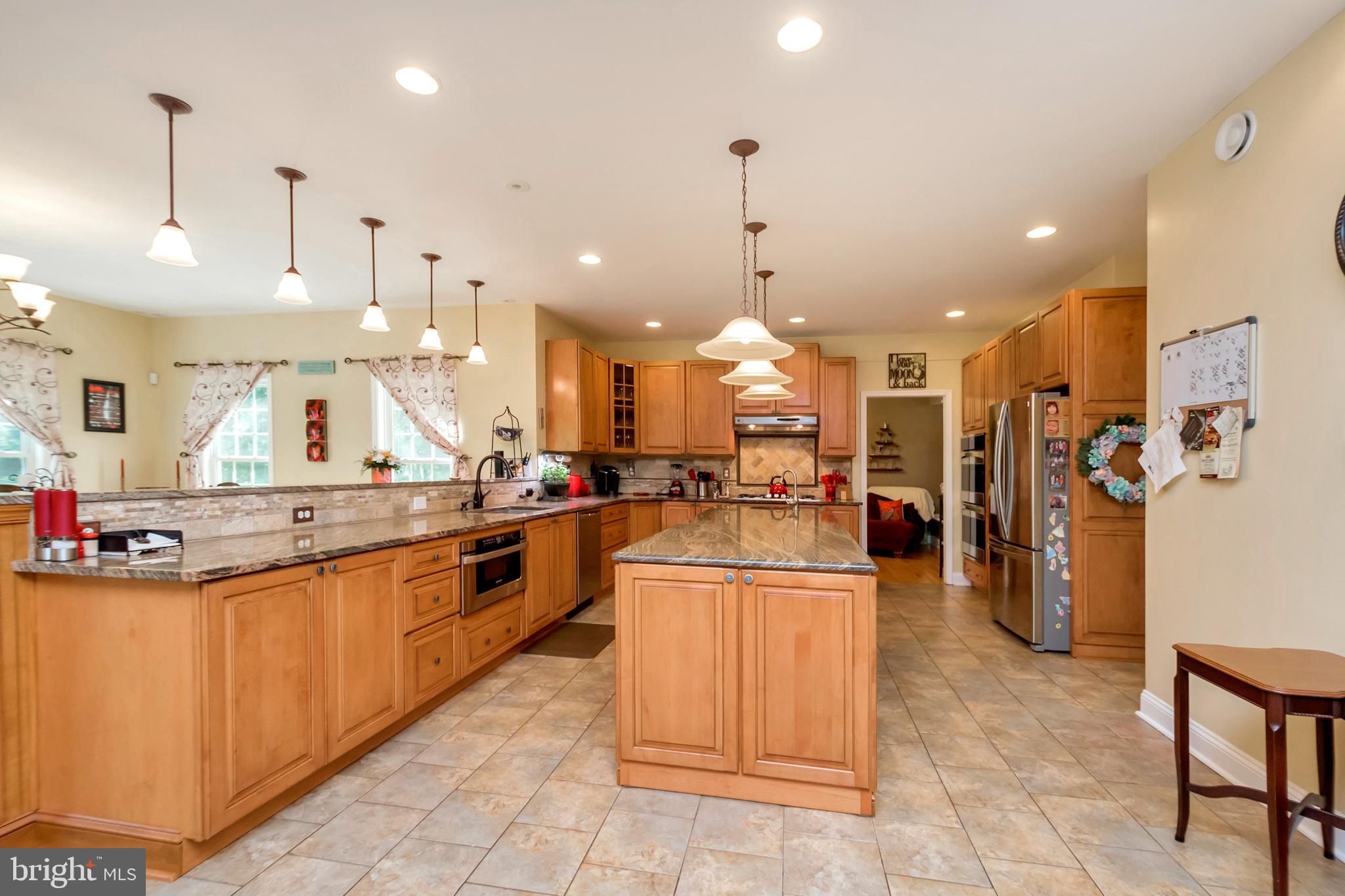 45 Crowncrest Road Fredericksburg, VA 22406 - Photo 5 of 17 a kitchen with stainless steel appliances kitchen island granite countertop a sink and a refrigerator