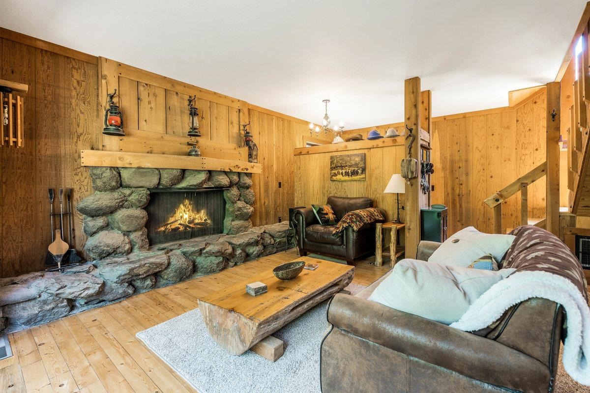 3600 Dinah Road Carnelian Bay, CA 96140 - Photo 11 of 26 a living room with furniture a fireplace and a floor to ceiling window