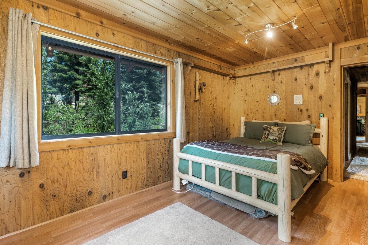 3600 Dinah Road Carnelian Bay, CA 96140 - Photo 16 of 26 a view of a balcony with wooden floor and iron stairs