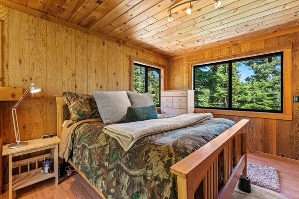 a bedroom with furniture and a large window
