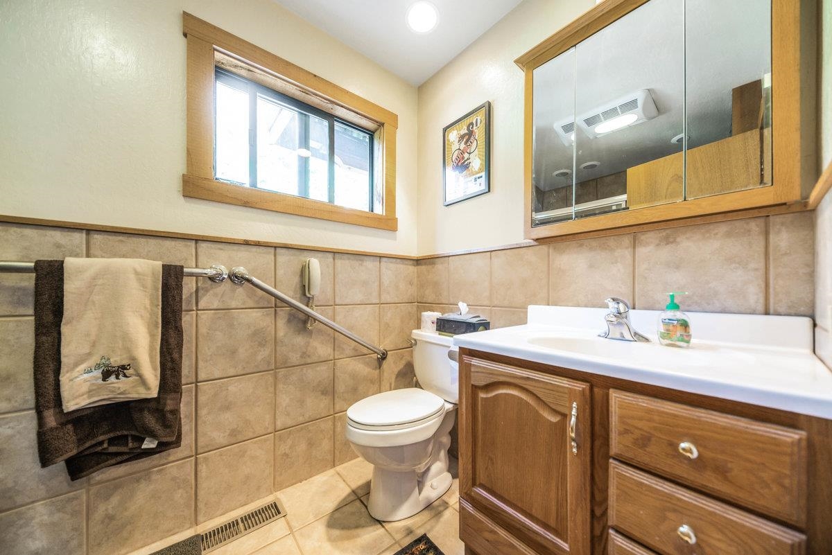 3600 Dinah Road Carnelian Bay, CA 96140 - Photo 20 of 26 a bathroom with a sink a toilet and a mirror