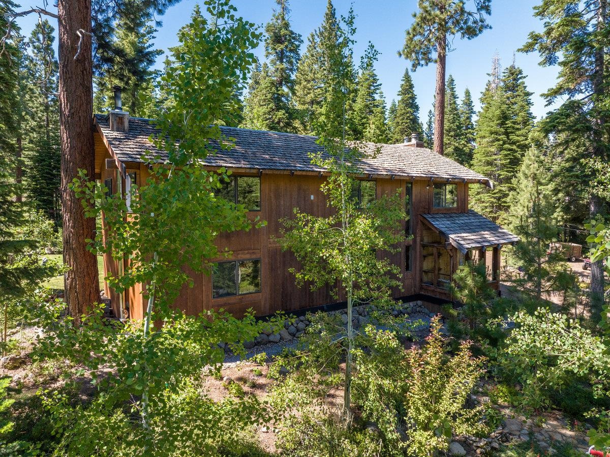 3600 Dinah Road Carnelian Bay, CA 96140 - Photo 2 of 26 a view of a garden with a table and chairs under an umbrella