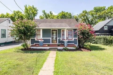 a view of a house with swimming pool and sitting area