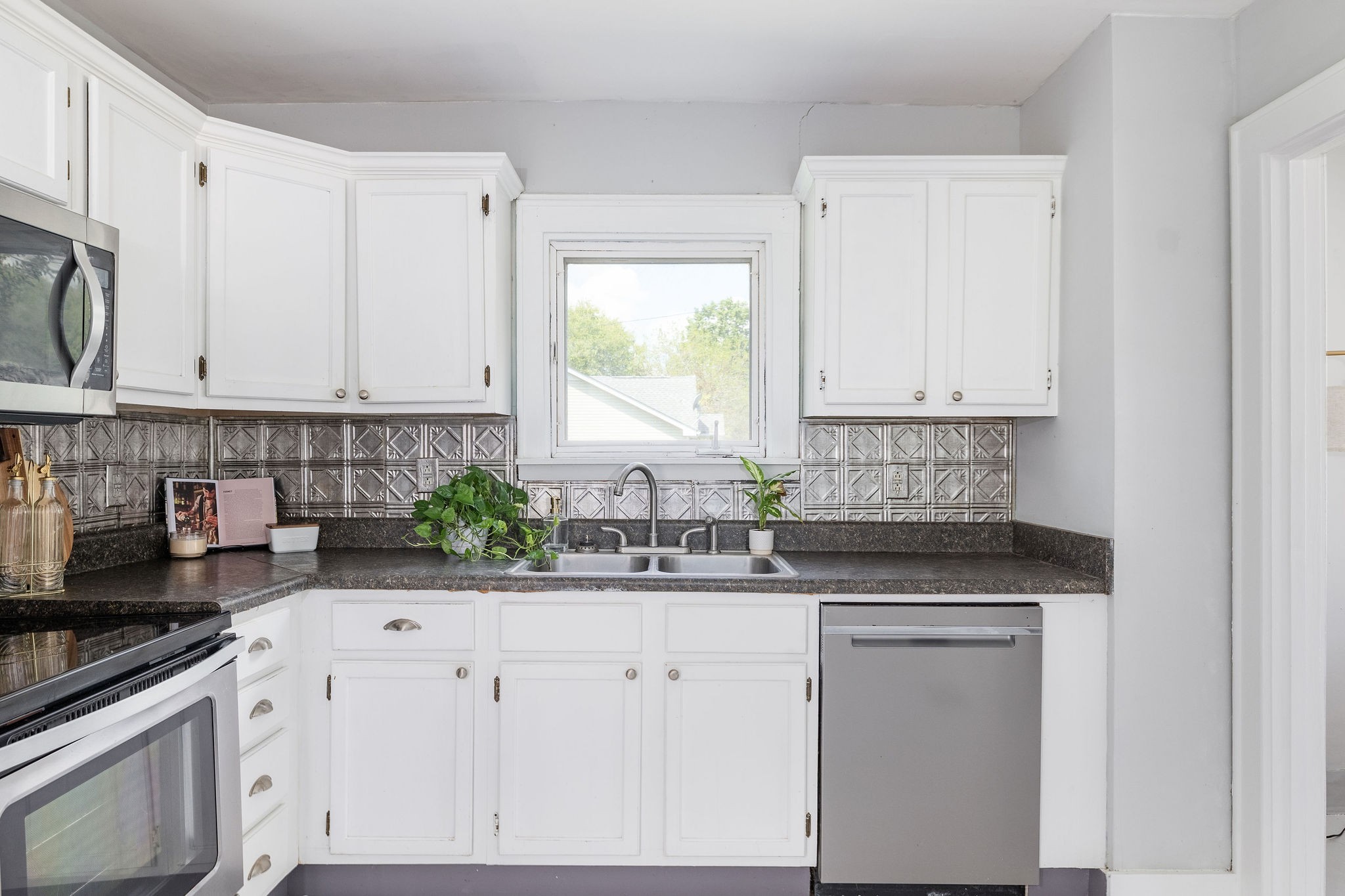320 Cherry Street Madison, TN 37115 - Photo 8 of 30 a kitchen with stainless steel appliances white cabinets and a stove top oven