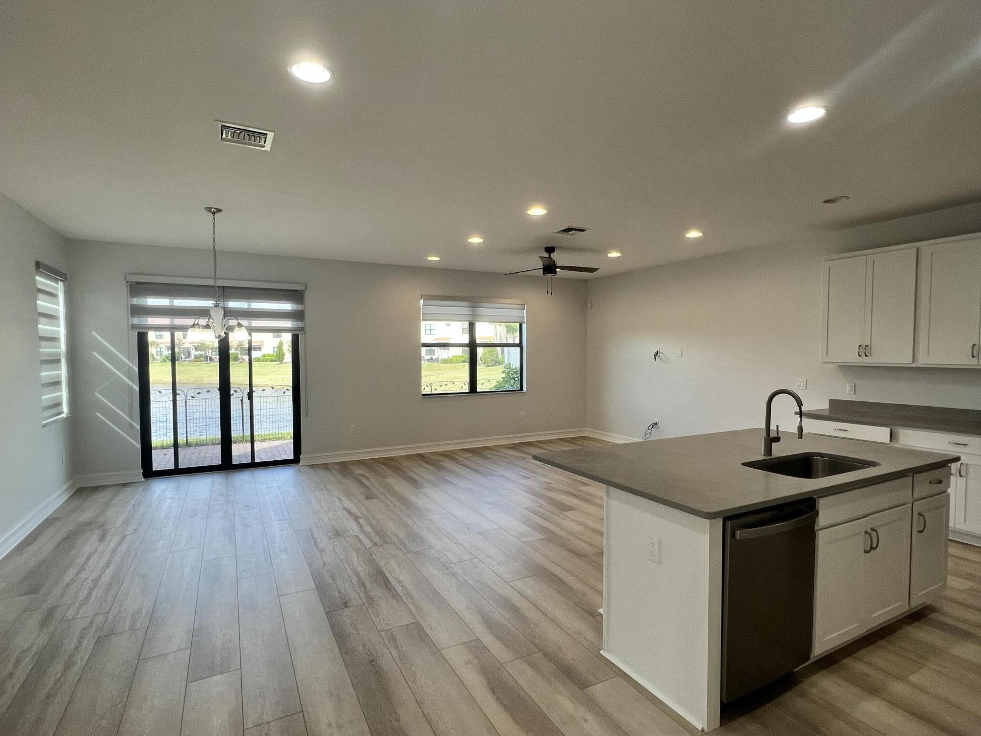10043 Akenside Drive Boca Raton, FL 33428 - Photo 11 of 30 a kitchen with a sink stove and cabinets