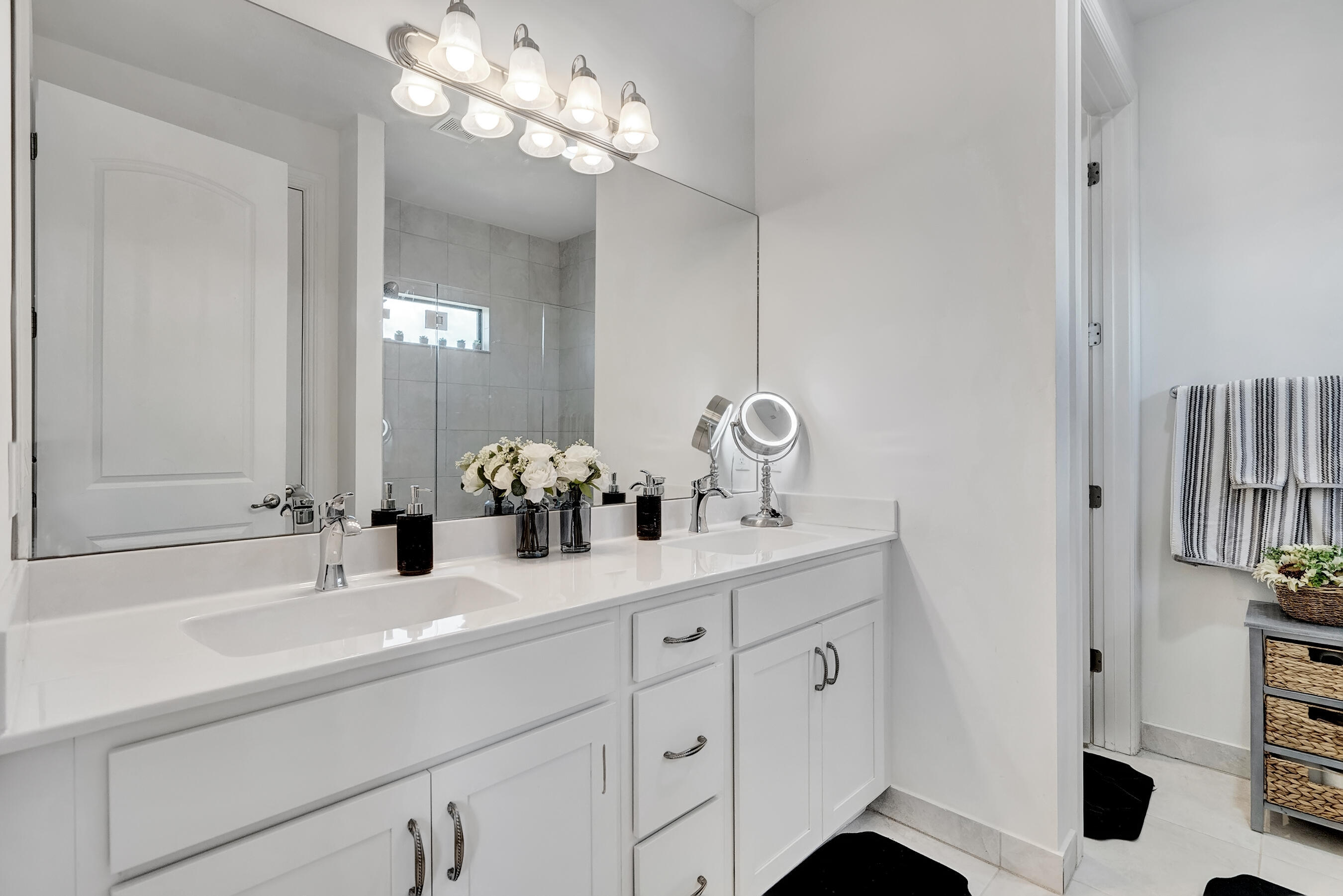 10043 Akenside Drive Boca Raton, FL 33428 - Photo 14 of 30 a bathroom with a sink double vanity and a mirror