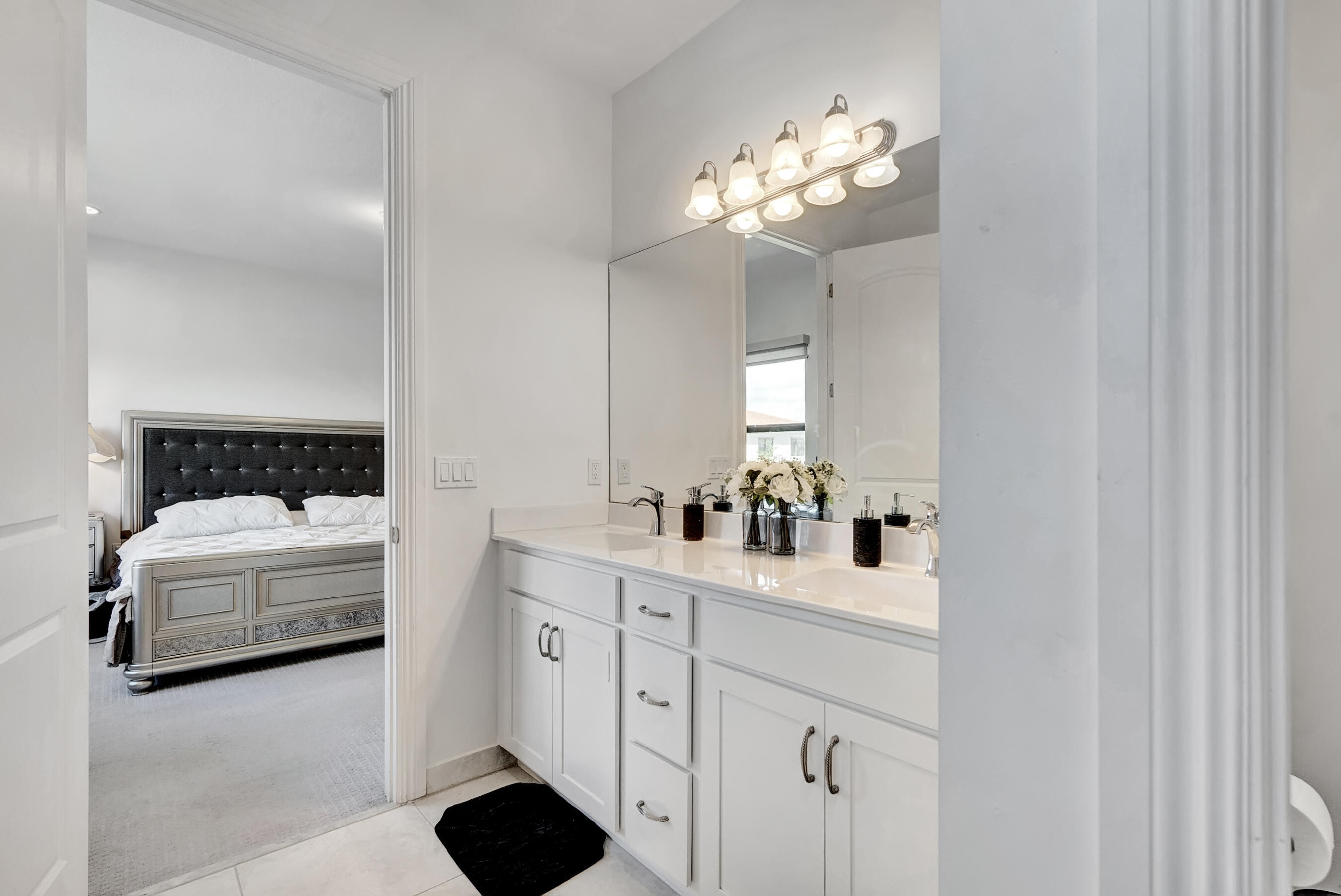 10043 Akenside Drive Boca Raton, FL 33428 - Photo 15 of 30 a en suite bathroom with a double vanity sink and a mirror