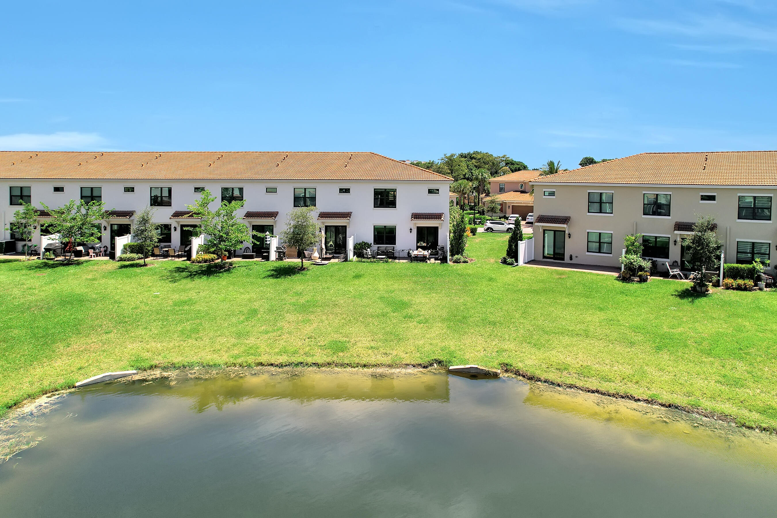 10043 Akenside Drive Boca Raton, FL 33428 - Photo 3 of 30 a view of a building with a big yard