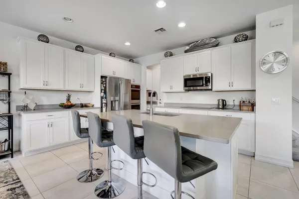 a kitchen with a sink cabinets and stainless steel appliances