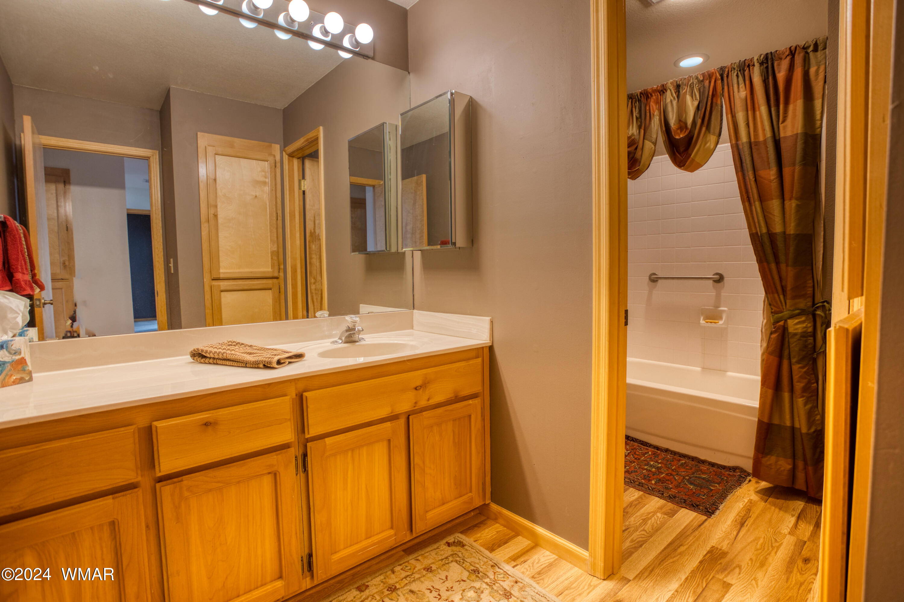 2727 Juniper Circle, Unit 37 Pinetop, AZ 85935 - Photo 16 of 33 a bathroom with a granite countertop sink and a mirror
