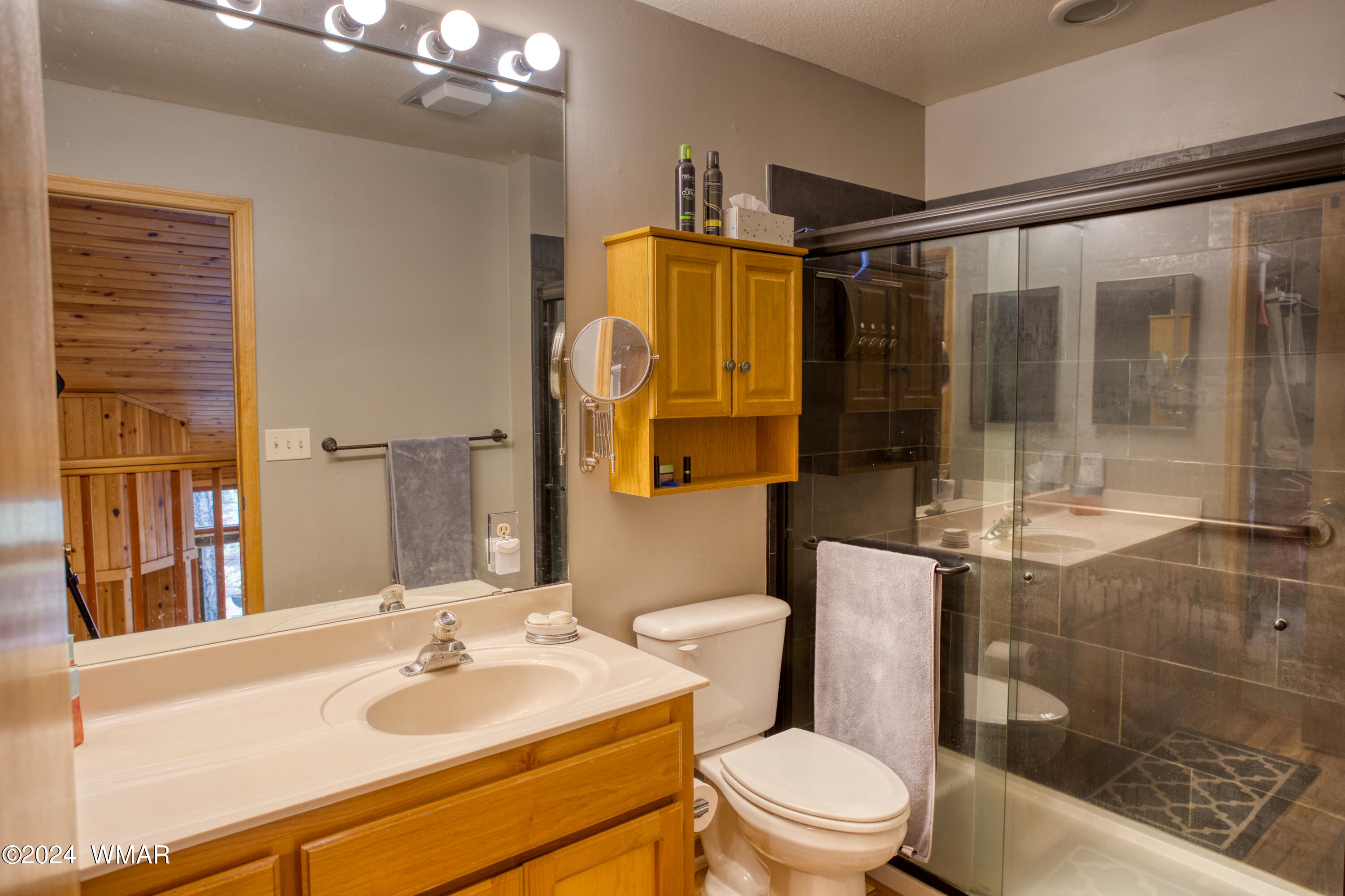 2727 Juniper Circle, Unit 37 Pinetop, AZ 85935 - Photo 23 of 33 a bathroom with a sink toilet mirror and shower