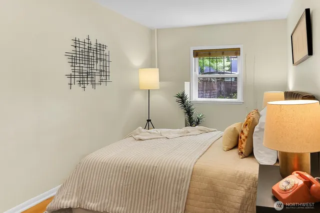 a bedroom with a bed and a window