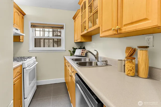 a kitchen with a sink a stove and a microwave