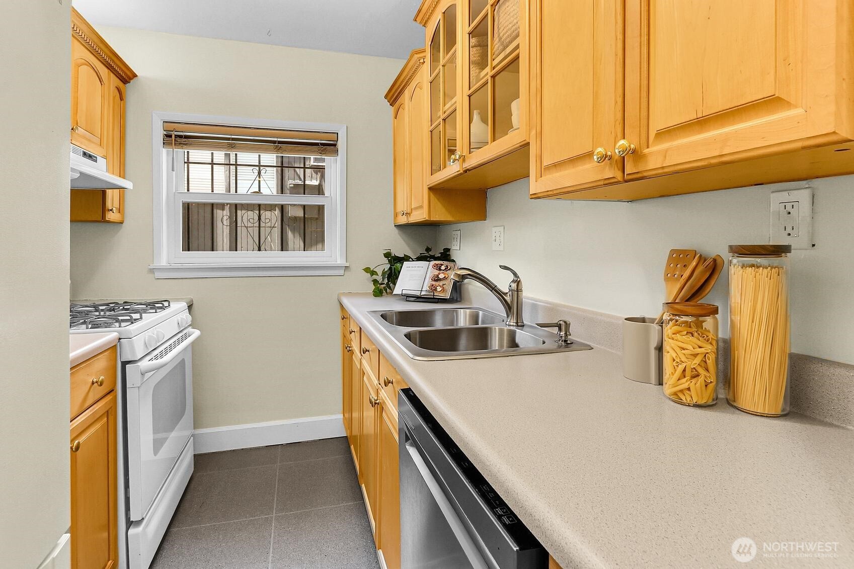 516 East Thomas Street, Unit 105 Seattle, WA 98102 - Photo 5 of 15 a kitchen with a sink a stove and a microwave