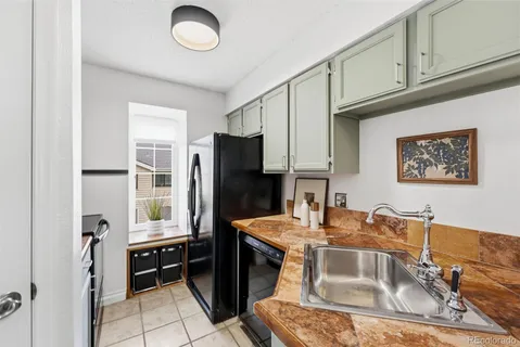 a kitchen with stainless steel appliances granite countertop a stove a refrigerator and a microwave