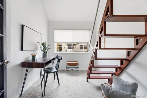 a view of staircase with furniture and floor to ceiling window