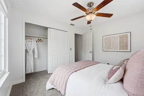 a bedroom with bed and a large window