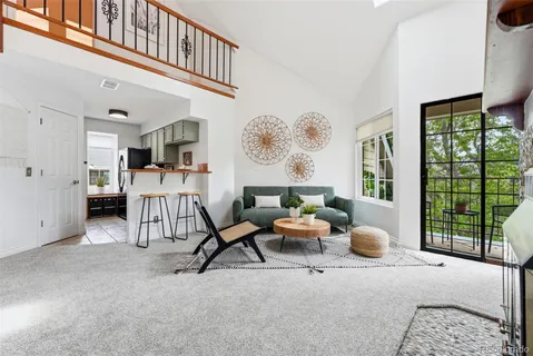 a living room with fireplace furniture and a large window