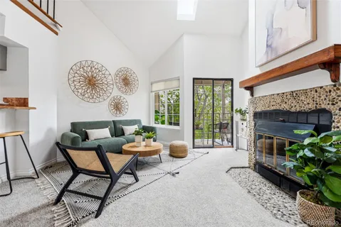 a living room with furniture a window and a fireplace