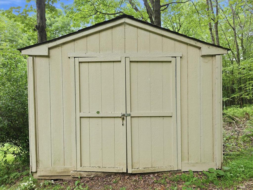 520 Highland Hill Road Jim Thorpe, PA 18235 - Photo 65 of 83 A quaint garden shed offers extra storage amidst natural surroundings.