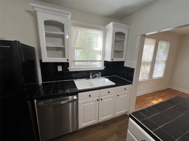 a kitchen with granite countertop a stove and a refrigerator