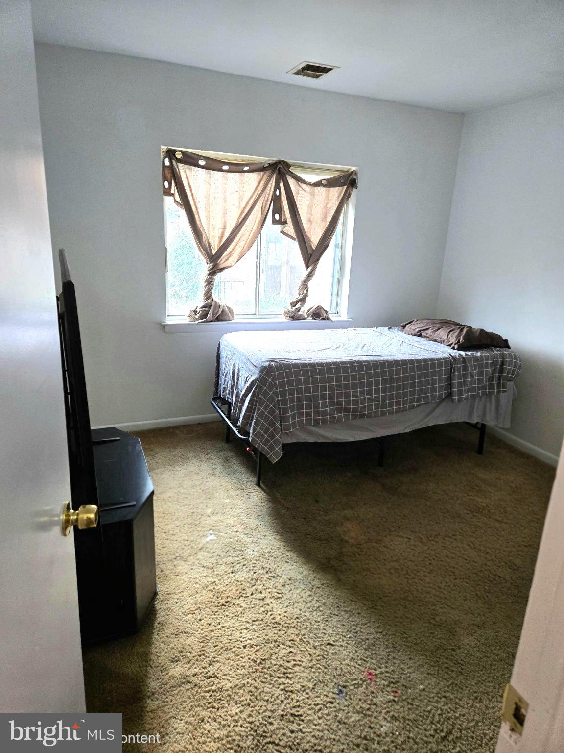 3384 Hewitt Avenue, Unit 201 Silver Spring, MD 20906 - Photo 8 of 10 a bedroom with a bed and a window