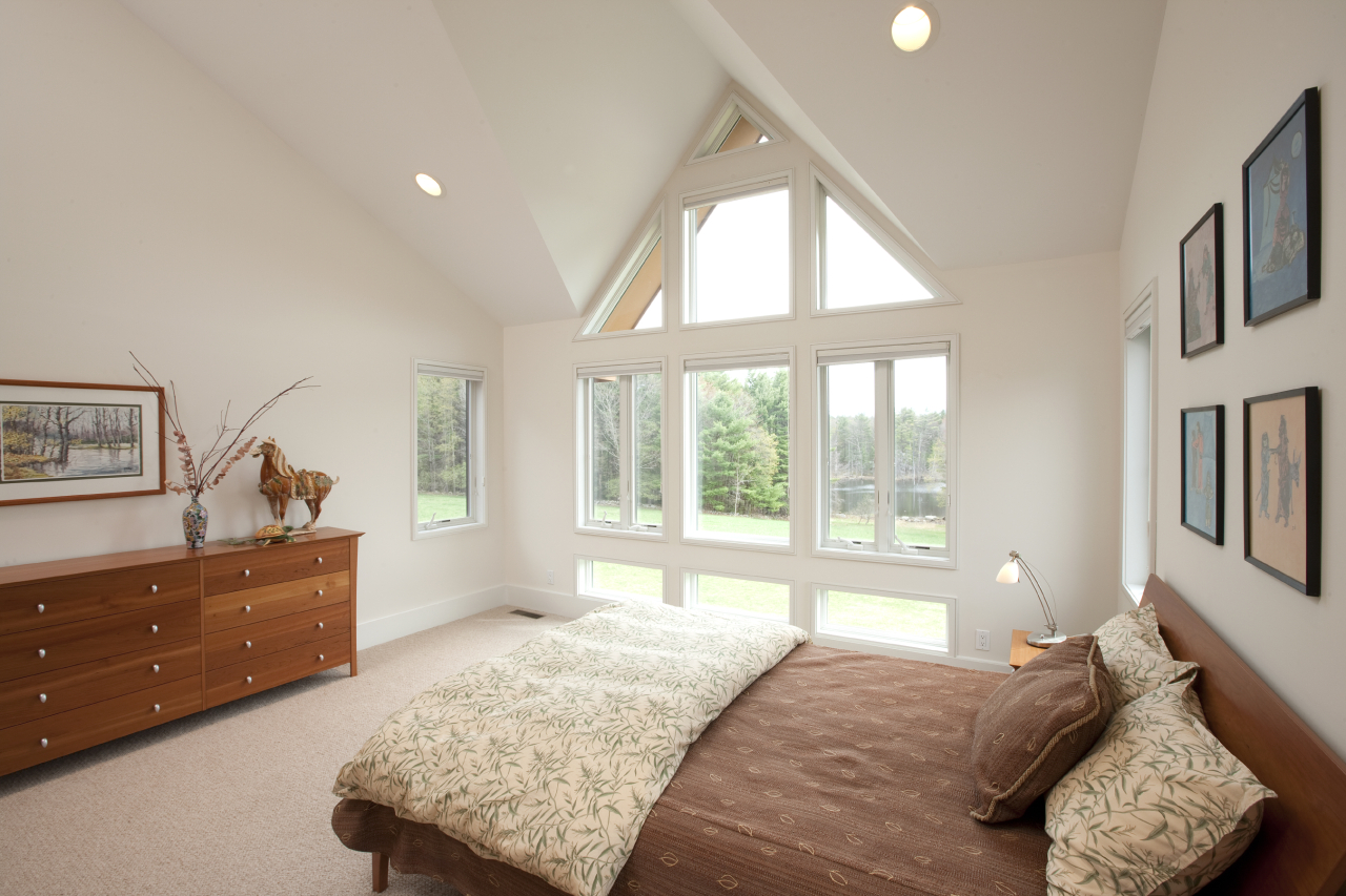 72 A Brett Road Monterey, MA 01245 - Photo 14 of 20 a bedroom with a bed and a dresser next to a window