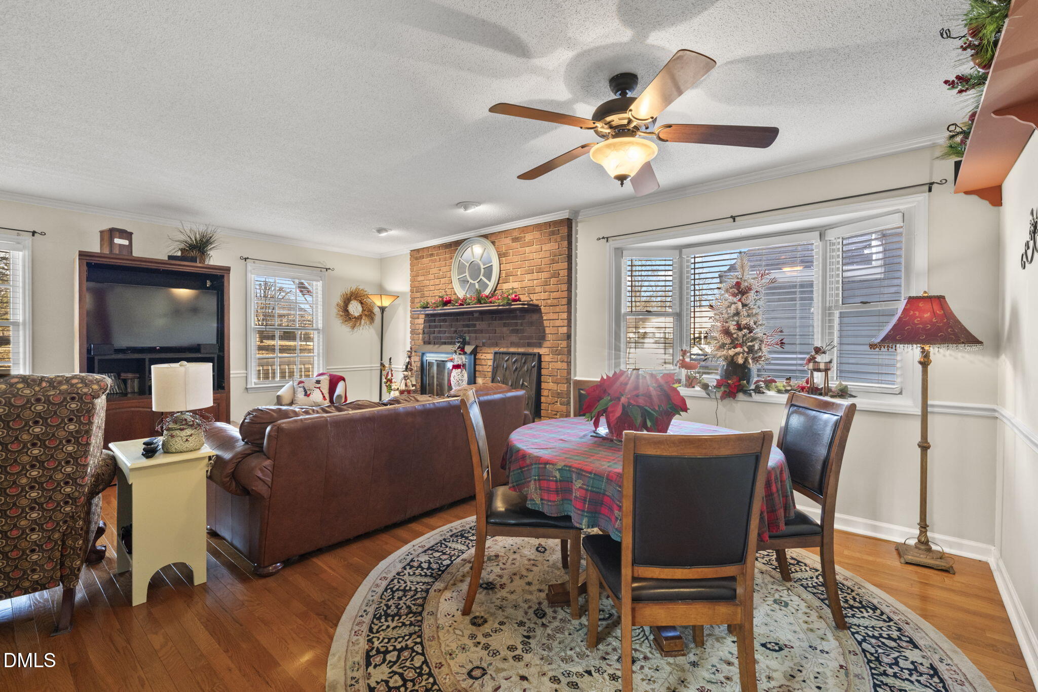 207 South Adams Street Durham, NC 27703 - Photo 11 of 49 a living room with furniture a fireplace and a chandelier