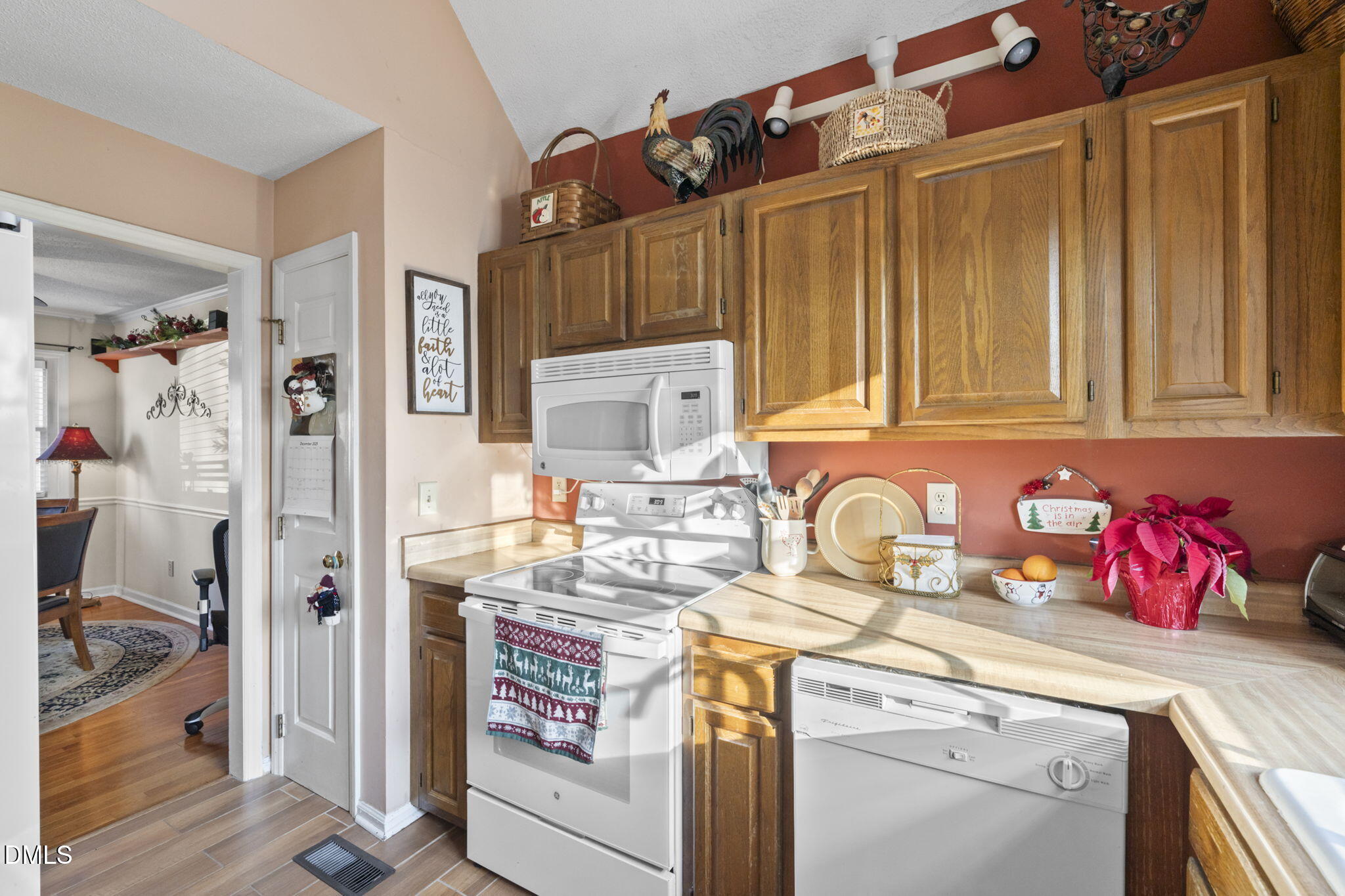 207 South Adams Street Durham, NC 27703 - Photo 16 of 49 a kitchen with stainless steel appliances granite countertop a sink dishwasher and cabinets with wooden floor