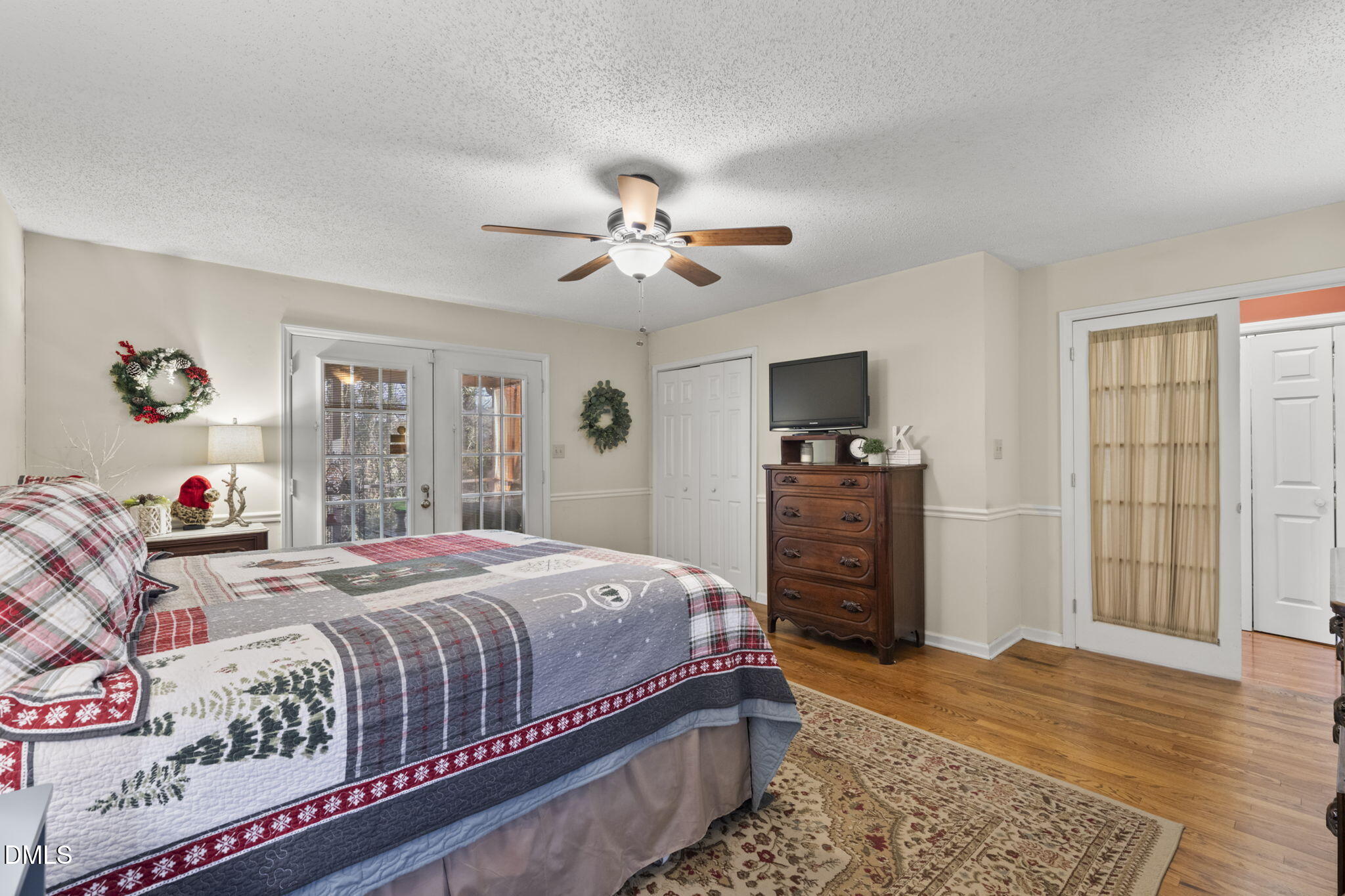 207 South Adams Street Durham, NC 27703 - Photo 27 of 49 a bedroom with a bed and a flat screen tv