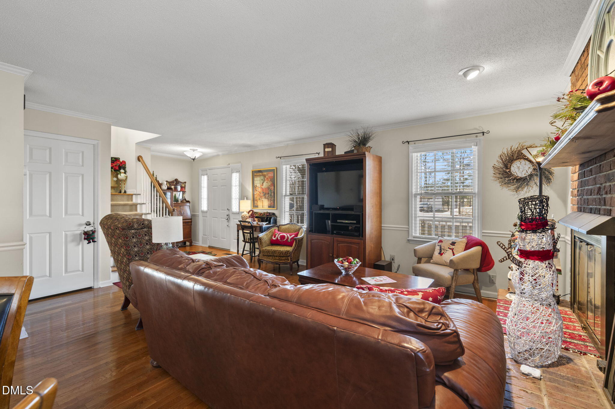 207 South Adams Street Durham, NC 27703 - Photo 9 of 49 a living room with furniture a flat screen tv and a floor to ceiling window