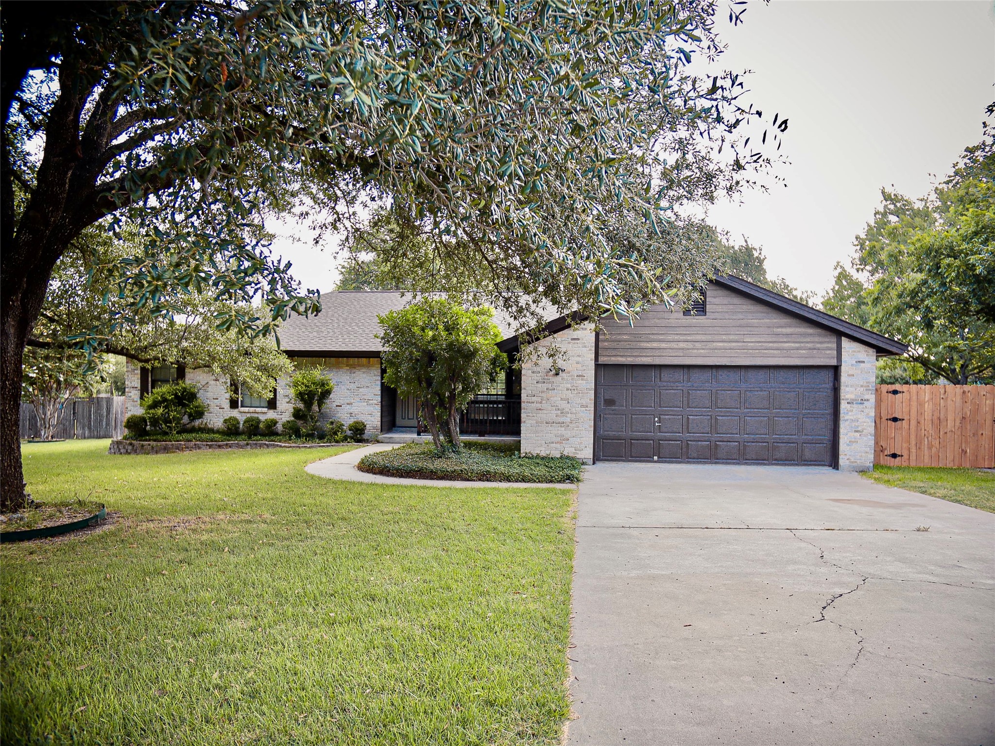 1612 Buttercup Road Pflugerville, TX 78660 - Photo 1 of 16 Mature trees and neat landscaping frame this inviting, well-maintained home.