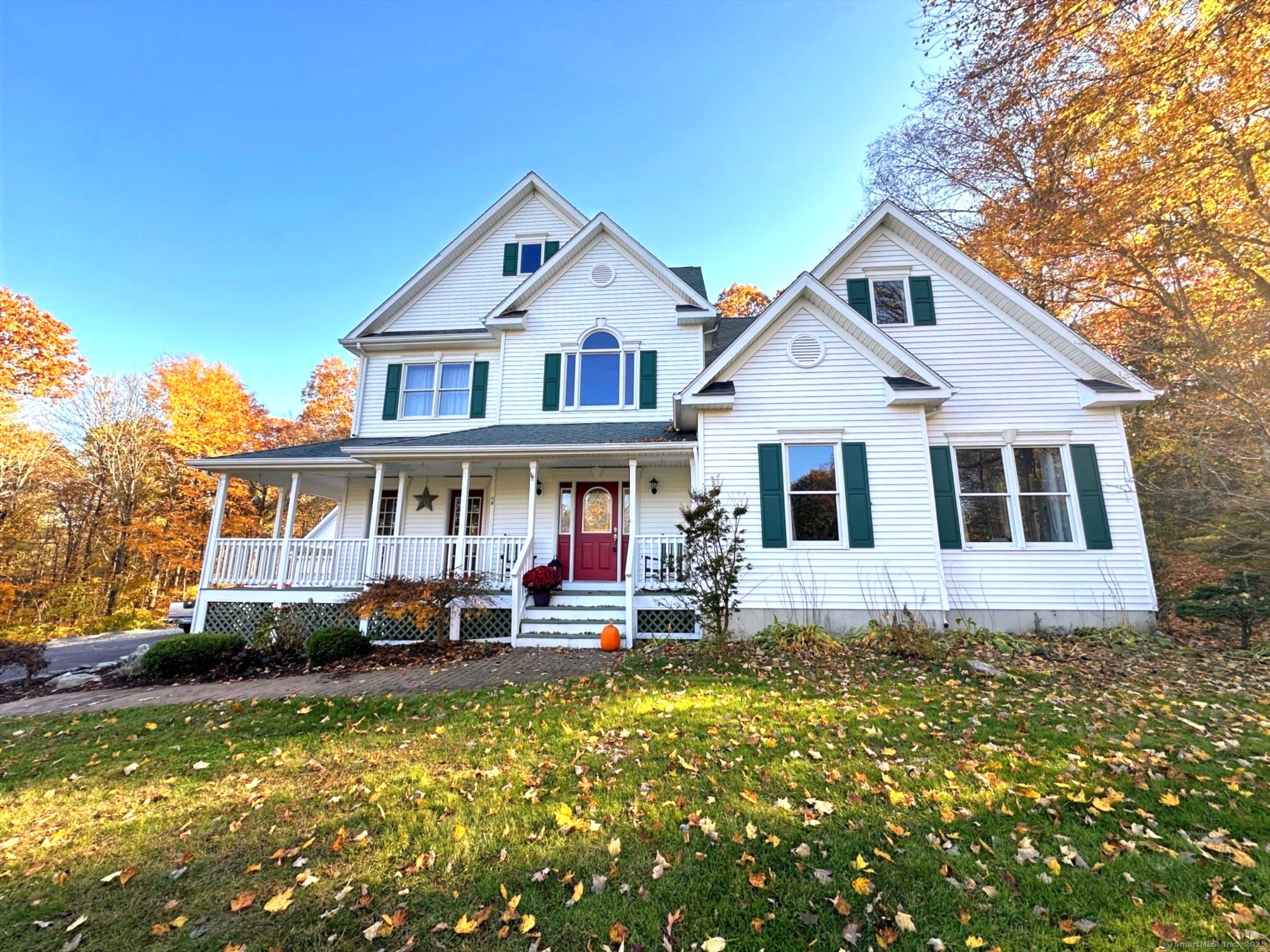 a front view of a house with a yard table and chairs