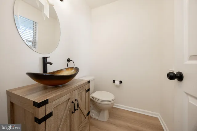 a bathroom with a toilet a sink and a mirror