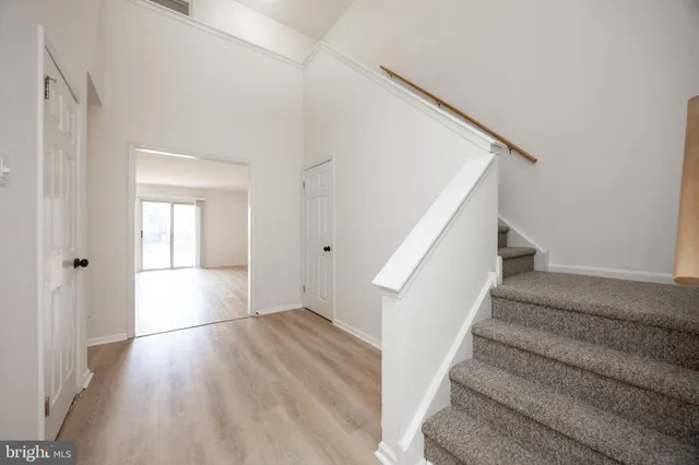 a view of entryway with wooden floor and stairs