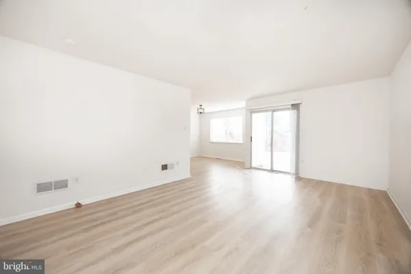 a view of an empty room and wooden floor
