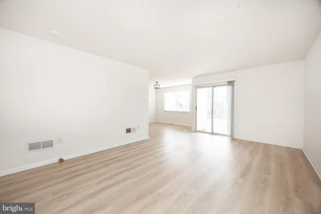 a view of an empty room and wooden floor