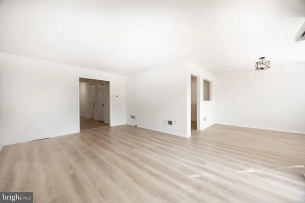 a view of a livingroom with wooden floor and cabinet