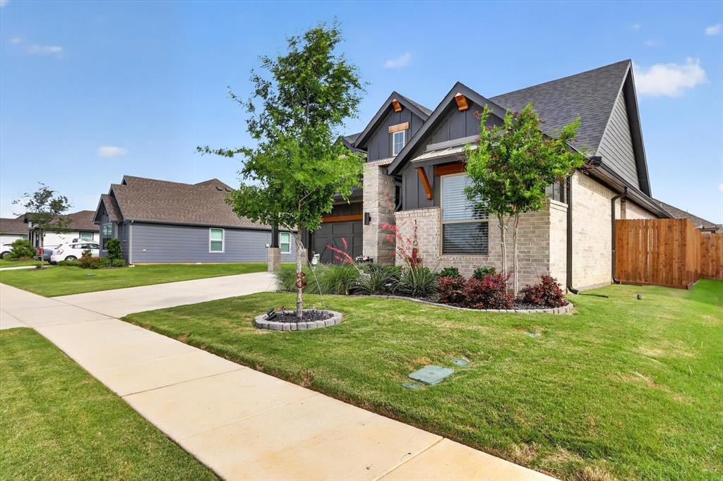 1740 Reverie Road Burleson, TX 76028 - Photo 2 of 37 a front view of a house with a yard and garage