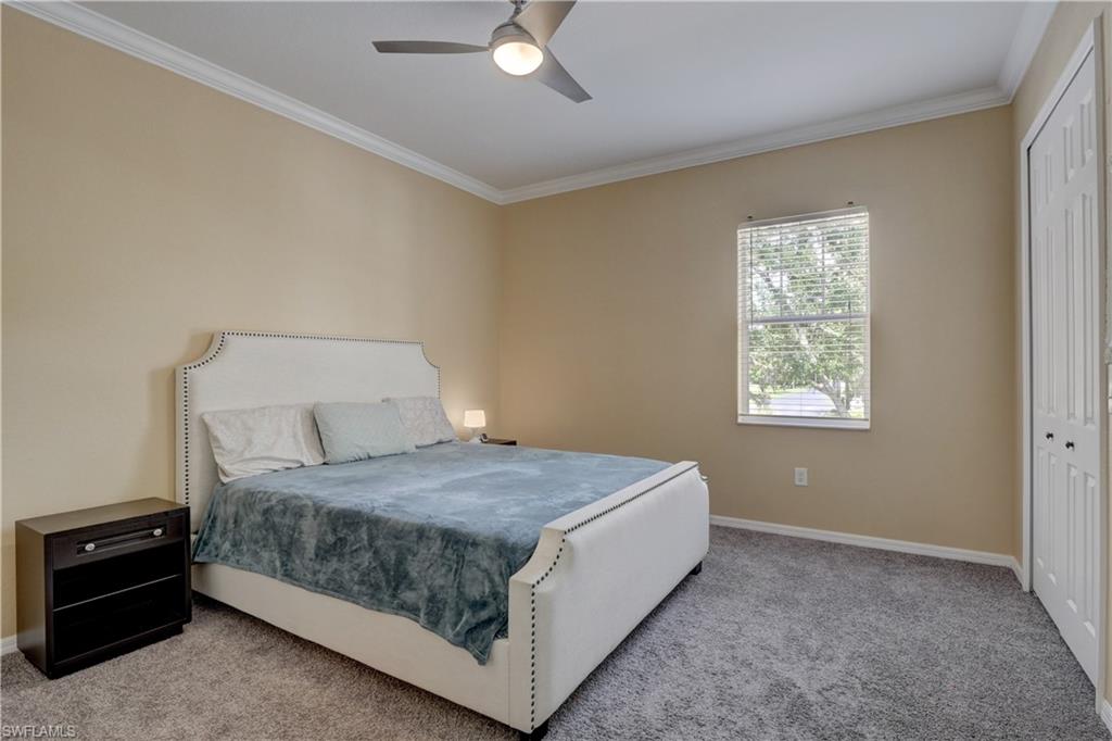 990 Peggy Circle, Unit 404 Naples, FL 34113 - Photo 14 of 26 a bedroom with a bed and window