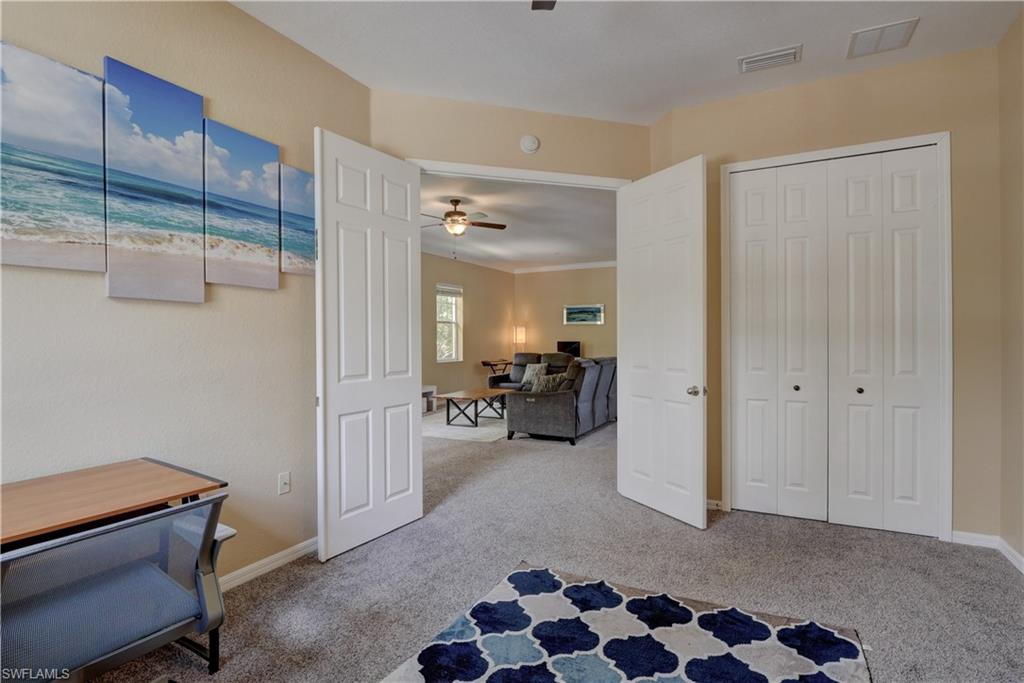990 Peggy Circle, Unit 404 Naples, FL 34113 - Photo 17 of 26 a view of hallway with livingroom and furniture