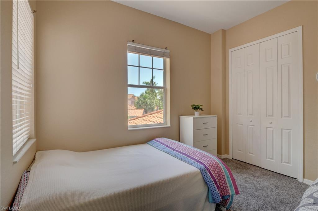 990 Peggy Circle, Unit 404 Naples, FL 34113 - Photo 18 of 26 a bedroom with a bed and a window