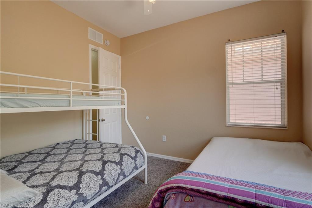 990 Peggy Circle, Unit 404 Naples, FL 34113 - Photo 19 of 26 a bedroom with a bed and a window