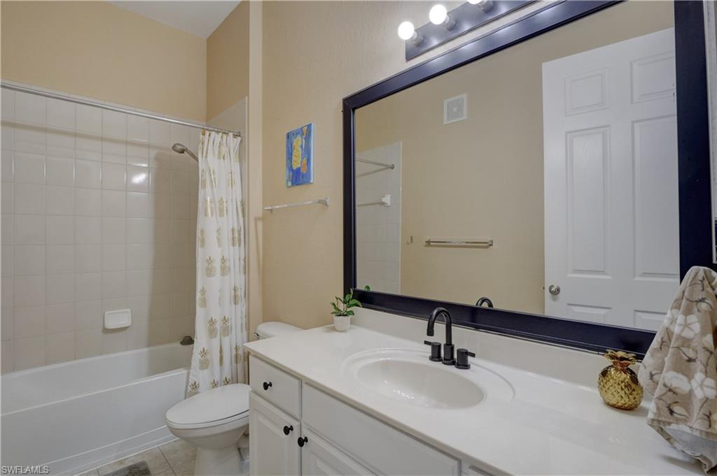990 Peggy Circle, Unit 404 Naples, FL 34113 - Photo 20 of 26 a bathroom with a sink a toilet and shower
