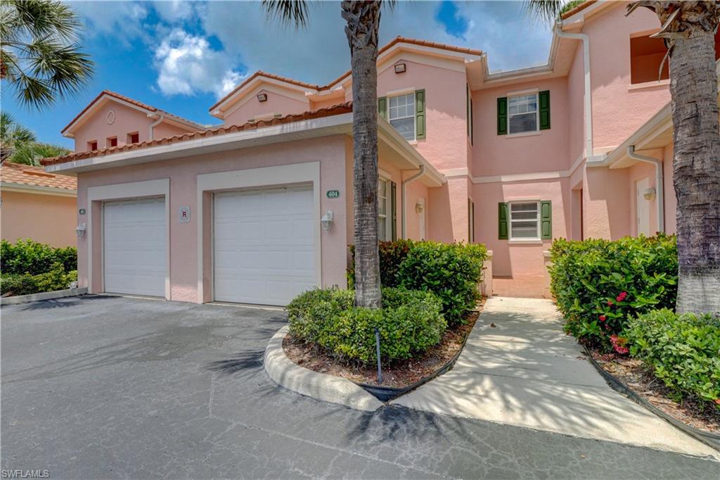 990 Peggy Circle, Unit 404 Naples, FL 34113 - Photo 2 of 26 front view of a house with potted plants